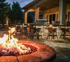 outdoor fire pit with outdoor furniture in background
